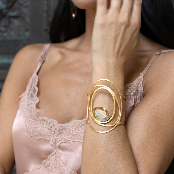 Gold sculptural cuff bracelet with large crystal
