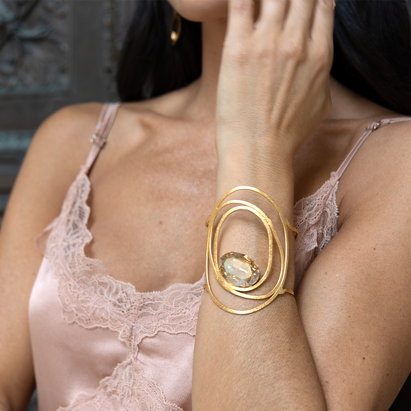 Gold sculptural cuff bracelet with large crystal