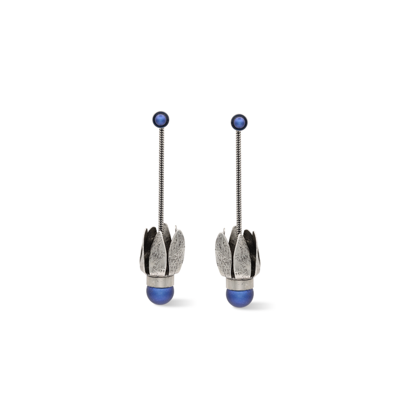 Silver tulip dangle earrings adorned with a dark blue