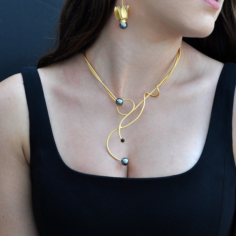 Gold sculptural necklace with black pearl