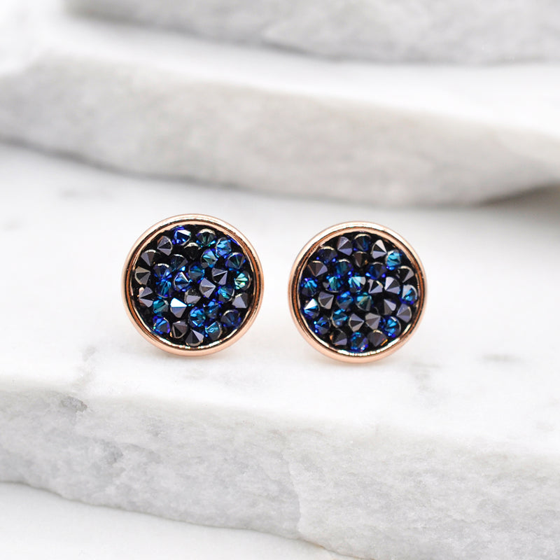 Rose gold round stud earrings with shiny blue Swarovski crystals