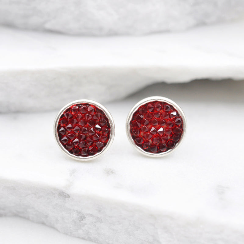 Silver round stud earrings with red Swarovski crystals