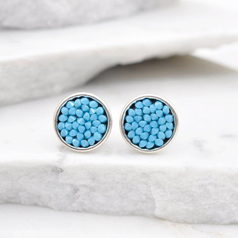 Silver stud earrings with turquoise Swarovski crystals.