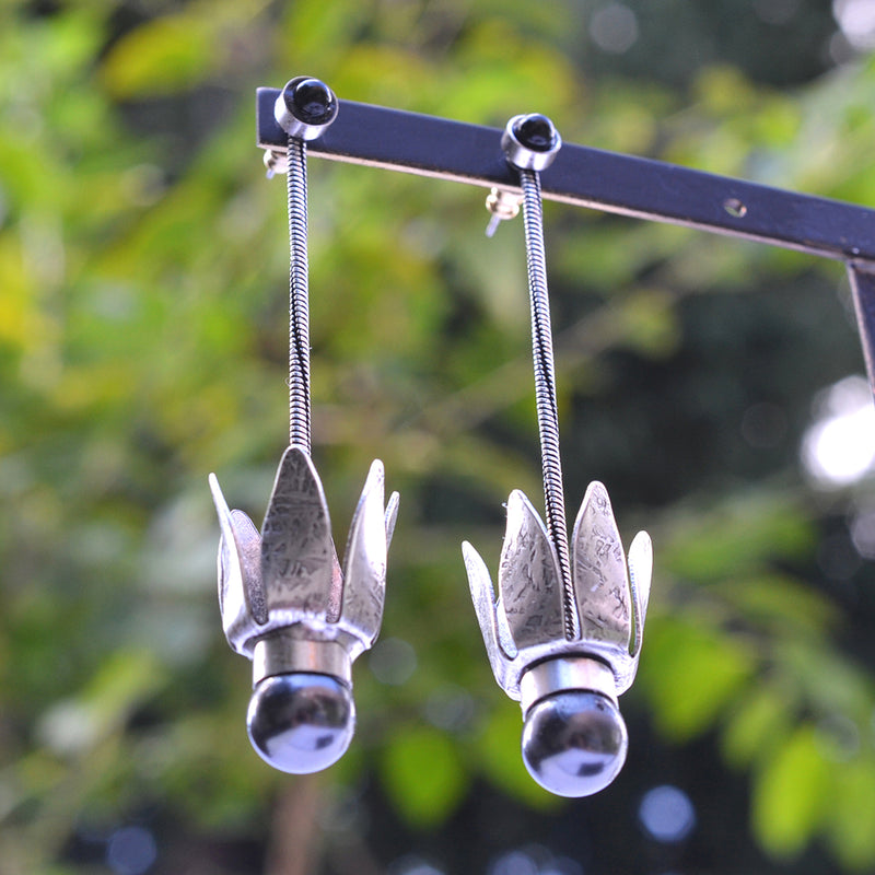 Silver tulip dangle earrings adorned with a black pearl